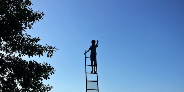 boy at top of ladder finding daily glimmers